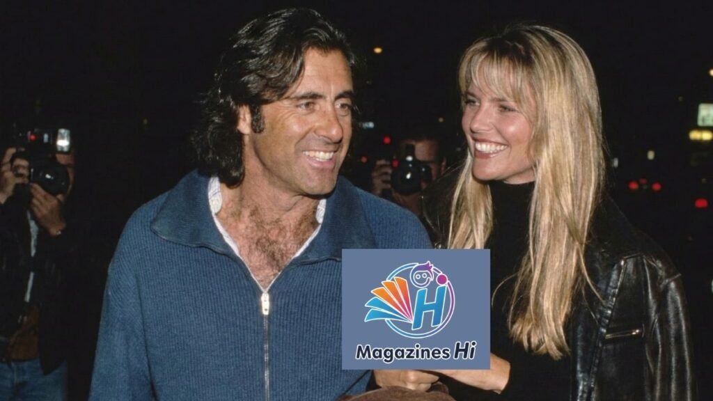 Christie Brinkley smiling with her third husband Richard Taubman in 1994, wearing a blue zip-up sweater and black leather jacket.